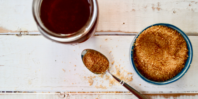 Cup of coffee and a spoonful of maple sugar