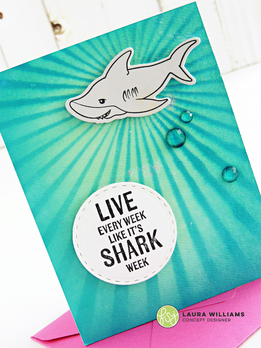 Colorful and fun handmade cards to celebrate Shark Week with the Shark Attack red rubber stamp set from FSJ. Make an underwater inspired card using the Sunny Day stencil and liquid colors ink to make the background and then add a simple stamped shark on top. #funstampersjourney #cardmaking #lauralooloo