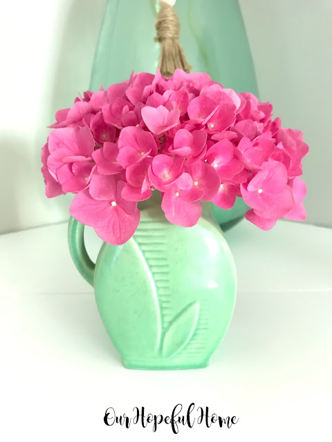 pink hydrangeas green pottery vase