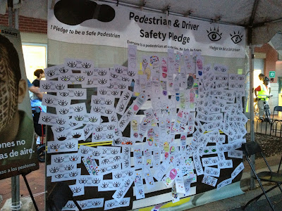 The crosswalk covered in pedestrian and driver safety pledges. 