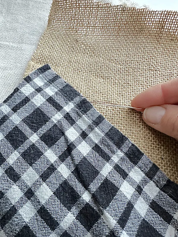 hand stitching black and white and burlap fabrics