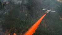 A US Air Force C-130 Hercules sprays retardant on a wildfire in Waldo Canyon, Colorado (Photo Credit: Staff Sgt. Stephany Richards/US Air Force) Click to Enlarge.