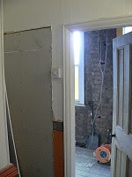 Landing with old bathroom door closed off