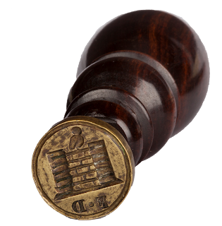 A wooden handled liquorice stamp, with a design of Pontefract Castle and the initials F D