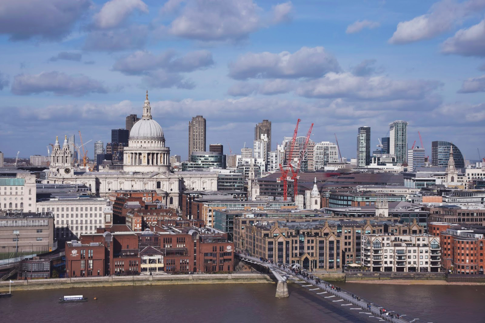 Taken from the top of the Tate Modern gallery in London. The London skyline is in full view with noticeable buildings such as St Pauls down below.