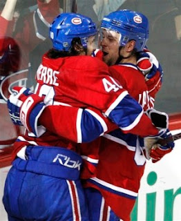 Guillaume Latendresse and Maxime Lapierre hugging and getting ready to kiss