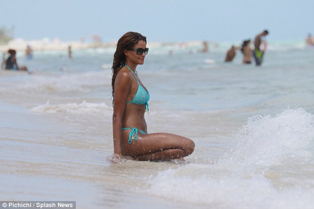 Bikini-clad Claudia Jordan enjoys the sand and surf with friend Aisha Thalia in Miami