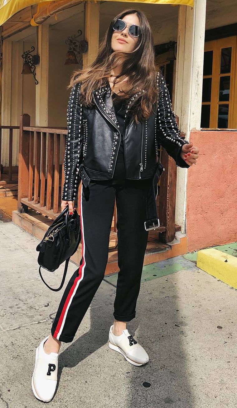 what to wear with a biker jacket : top + black bag + striped pants + white sneakers