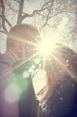 Husband and Wife kissing in sun