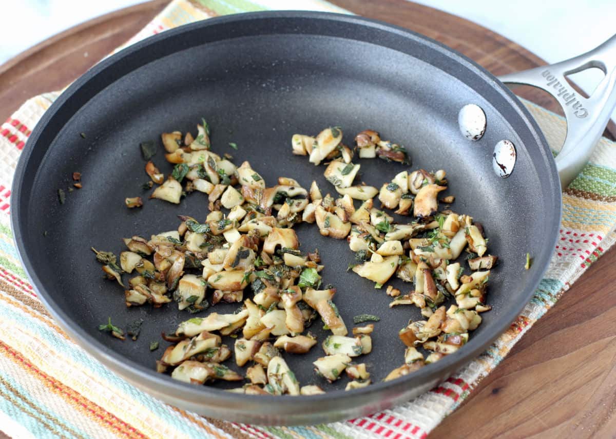 Mushrooms sautéed in a pan.