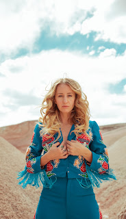 Photo of Margot Price in a blue dress.