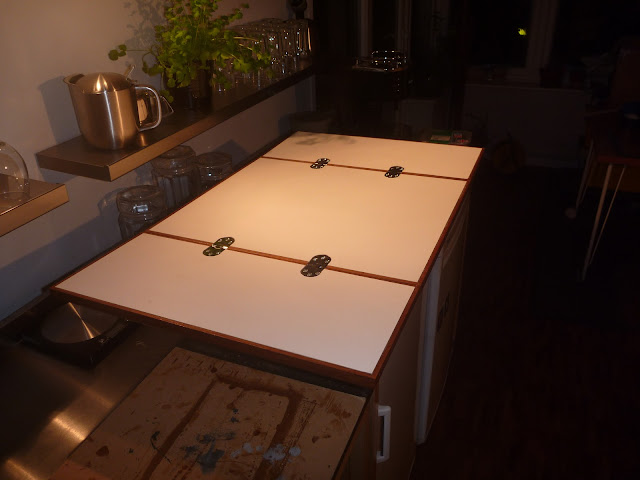 Opened tabeltop for Lagun table. Teak fiddle rails, WISA Multiwall surfaces, and chrome counterflap hinges.