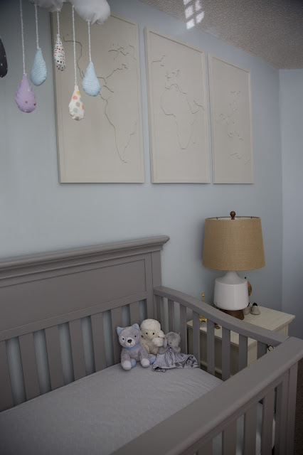 A travel and adventure-inspired gender neutral nursery with pops of burlap, pale gray, white, blue, and green.