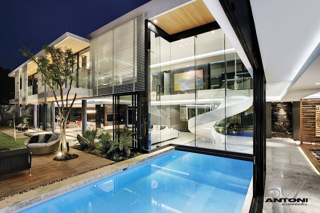 Picture of the pool and the house as seen from the house at night