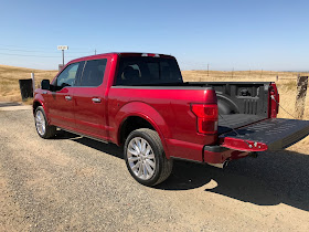 Rear 3/4 view of 2019 Ford F-150 4X4 SuperCrew Limited with tailgate down.