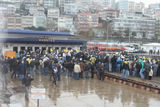 Fans marching past the building on the jetty