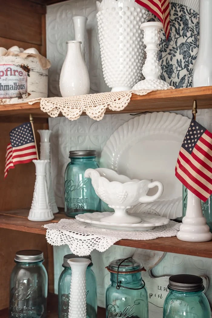 milk glass, mason jars, doilies, flags