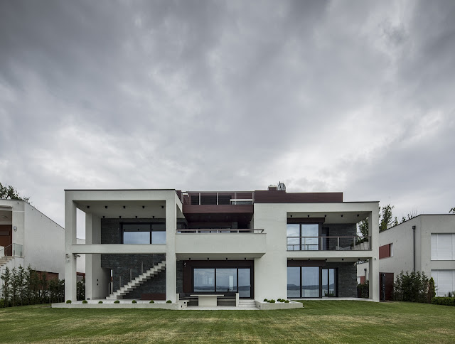 Modern home from the backyard lawn 