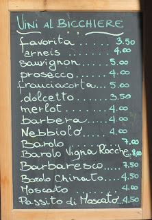 Wines by the glass listing at an Italian cafe.