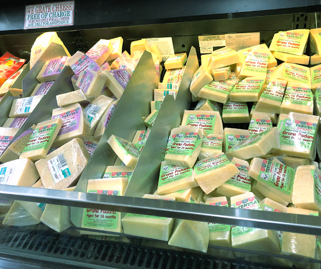 Choosing from mounds of Italian cheese at Tenuta's in Kenosha, Wisconsin