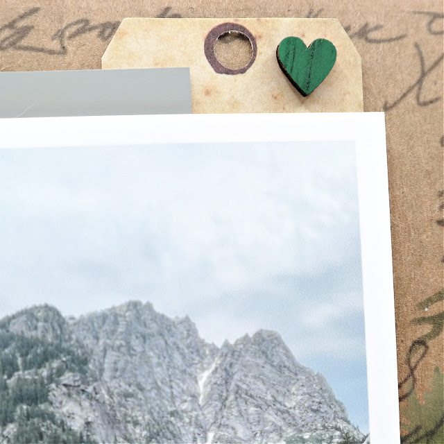 Mountain Time Grand Teton Vacation Scrapbook Layout with Stenciled Mountains and Trees Background, Die-Cut Pocket Watch, and Wood Letter Tile Title.