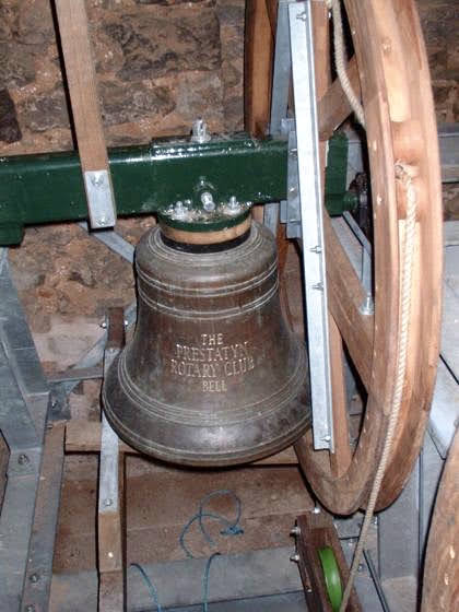 Photo showing one of the installed church bells to bell tower above entrance.
