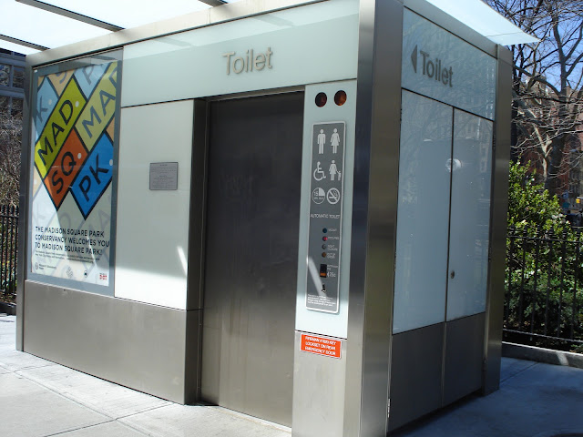 NYCFL-29 Madison Square Park, self-cleaning public toilet (located across 11 Madison Avenue, Met Life Insurance North Building)