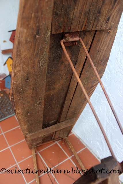 Eclectic Red Barn: Old ironing board with rusty legs and loaded with straw