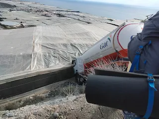 Camion on a slope touching a greenhouse