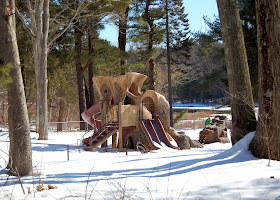 the playground does blend in with the winter trees