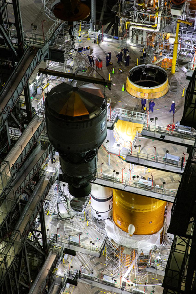 Inside the Vehicle Assembly Building (VAB) at NASA's Kennedy Space Center in Florida, engineers watch as the Interim Cryogenic Propulsion Stage (ICPS) is brought towards the Space Launch System (SLS) stack for mating...on July 5, 2021.