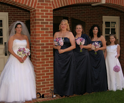 The bridal party wore marine blue gowns and carried bouquets with lavender