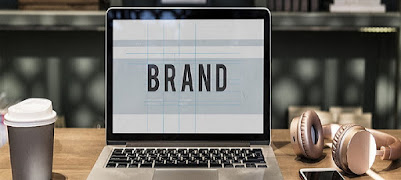 Brand sign on a computer screen on top of work table.