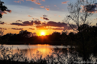 sunset over a lake photo by mbgphoto