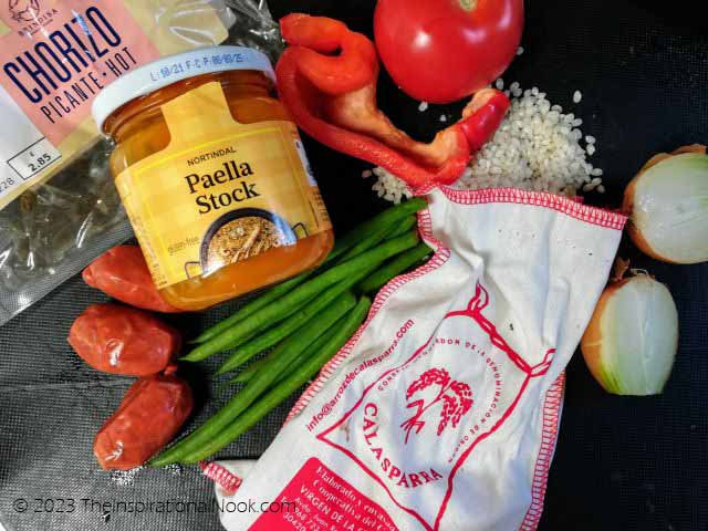 Ingredients for an authentic chorizo paella: Calasparra rice, saffron and paella stock.