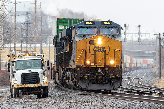 As rain falls, CSXT 966 passes a MoW truck at CP 286 in East Syracuse, NY.