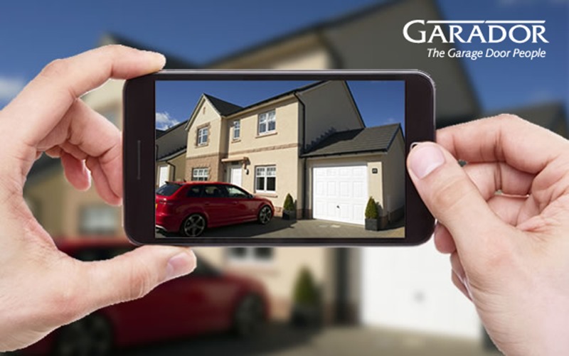 Image of smartphone photographing Garador garage door