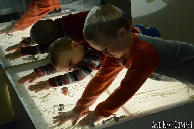 Toddler and preschooler playing with flour on the light table