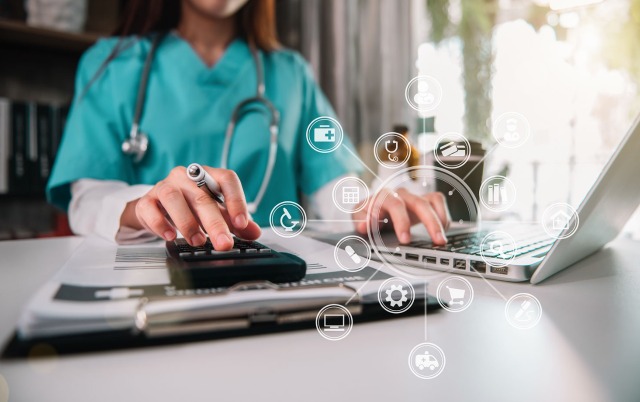 Woman in healthcare entering data into computer