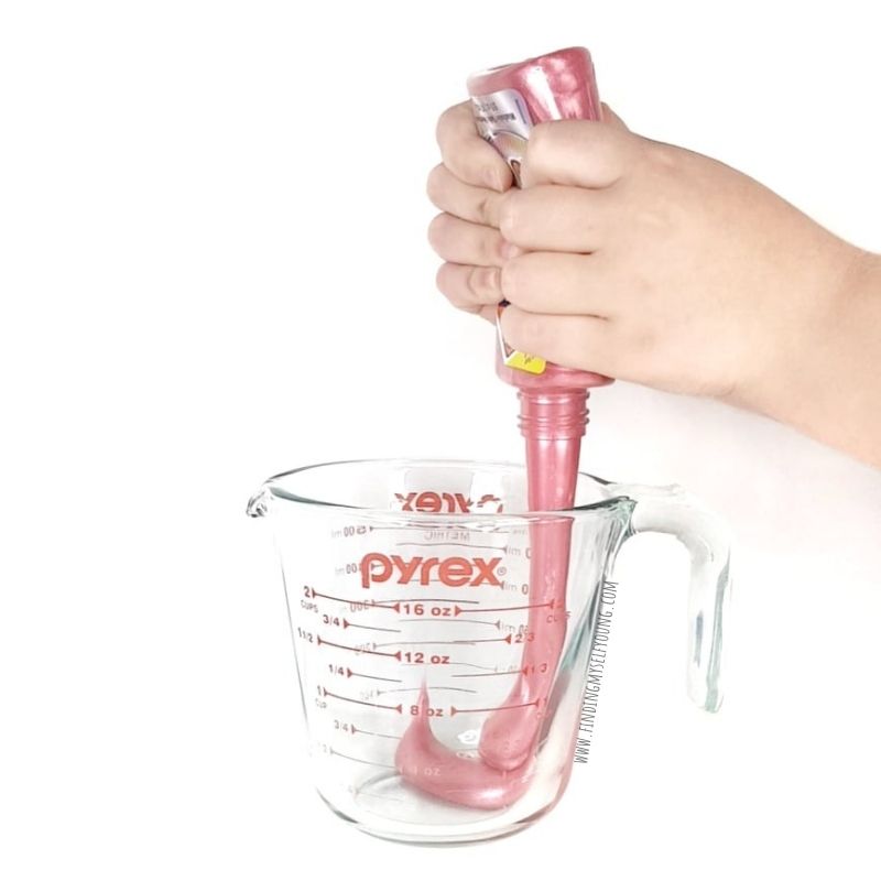 pouring metallic glue into a jug