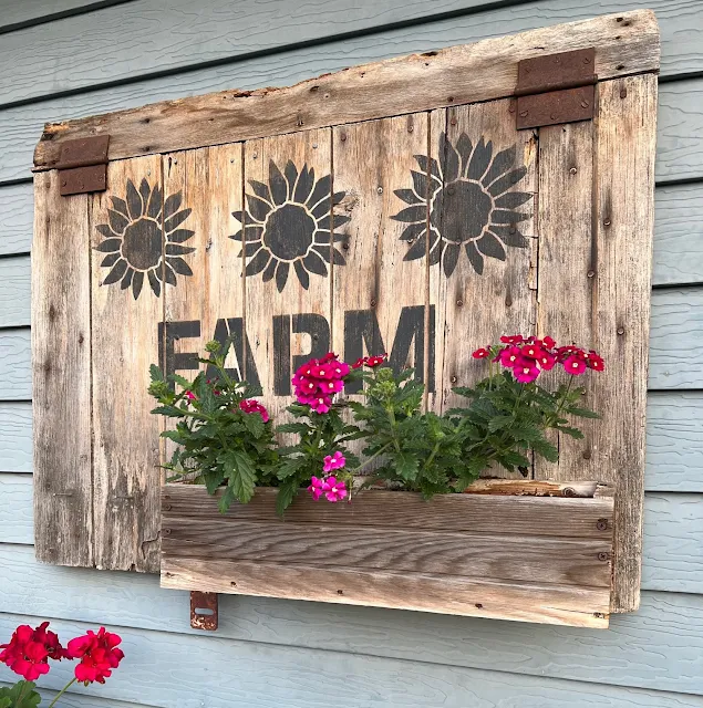 Photo of a barn door planter & verbenas.