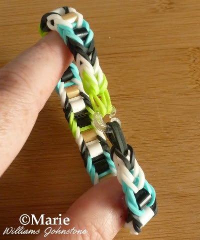 Rainbow loom bracelet with bead design in black, white, green and summer blue