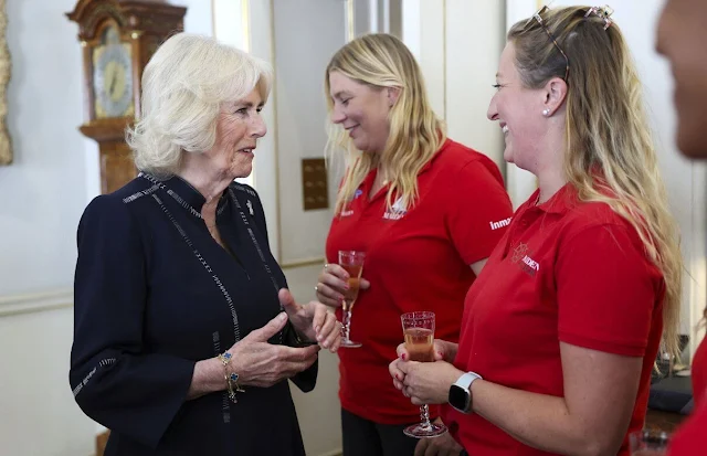 Queen Camilla wore a navy midi dress. Queen Camilla met with Tracy Edwards MBE