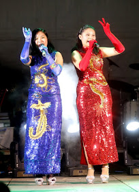 Singaporean sisters Susan (right) and Regina Yeo (left) take on the competition by playing musical instruments during their shows.