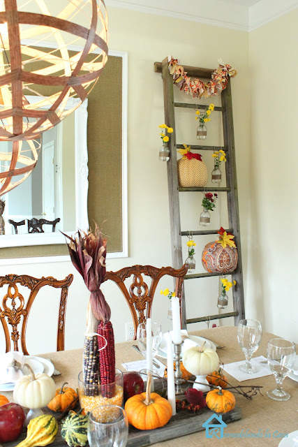 a formal dining set is dressed in a rustic way for Thanksgiving