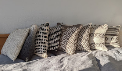 Photo of several knitted pillows in neutral colors