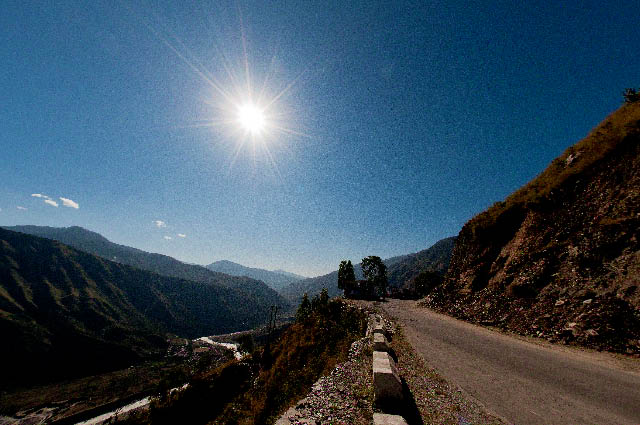 Last Stretch of Third Day to reach the most beautiful camping site called Kullu Sarahan - MTB Himachal 2010 : Posted by VJ SHARMA on www.travellingcamera.com : During the evening of third day, we were close to most exciting camping site of MTB Himachal 2010.. Kullu Srahan... A lovely place surrounded by snow covered hills.. It was a nice valley at 3200 meters... Clear view to star trails, blue/bright sky, waterfalls etc... Check the photographs of last stretch which was really tough for riders and most of us reached very late in the camp...Don't expect nice evenings in MTB Himachal 2010... In my opinion, evening were very boring... No group activity and zero interaction... but everyone used to enjoy in small groups...I was surprised to see that there was no arrangement for evening fun and it was hard to find any of the organizer after 9:00 pm.. After that every one used to disperse and none of us bothered to interact with each other during bonfire... I had got good company and we used to spend time in our tent with Rum and some local stuff :)We started last stretch from Baghipul which was the last point for noting down the time taken by riders to complete the day... Baghipul was near Shrikhand River and now we had to climb up 12 kilometers through an extremely rough road... Some of our vehicles stuck on the way...In my opinion slope of these hills was 65-75 degrees and most of us were scared for some time... but everyone was trying to hide it by cracking some jokes :) ... MTB 2009 winner was in our car because he was injured... He made us laugh us a lot....Only few areas are getting some sunlight and soon it will be dark.... It was the time when we had started from Baghipul and no one was aware about the next route ... Even no information about the distance we had to cover to reach the camp.... Organizers were not much bothered about all these details :)Gaddi going home in the evening.... Gaddi is the word which describe a shepherd in Himachal Pradesh...Colorful villages on the way to Kullu Sarahan from Baghipul.... These were fields of 'Chalai', a local crop... Chalai is used in winters and considered as a good source of warmth for the body...After climbing few kilometers we had clear views of shrikhand mountain ranges and all were covered with snow... Lovely colors of sunset were reflecting on the snow... although photograph is not showing the exact view.. It was wonderful...A noisy photograph of the day time... I think it's Satluj river on the left side of this photograph...Finally we reached Sarahan village and got our tents... It was the time to open the new bottle of RUM and get ready to fight with the chilling weather of the place...