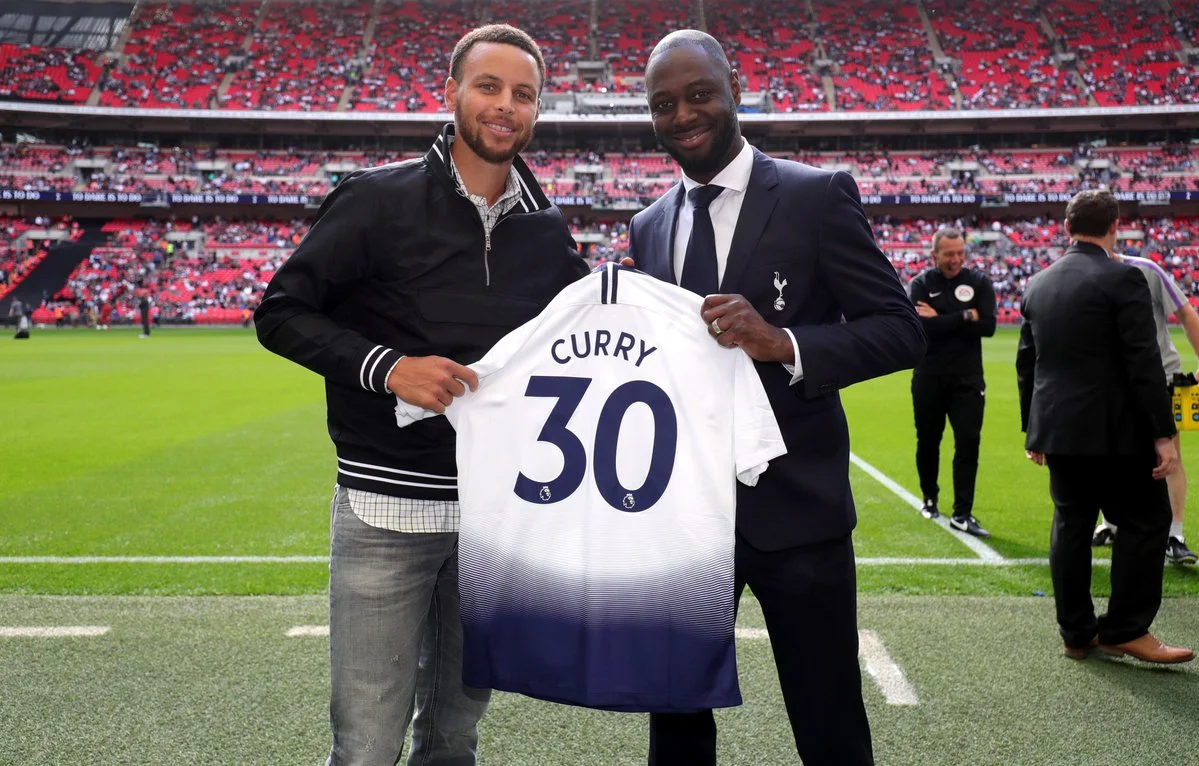 NBA superstar Stephen Curry poses with his own personalised Tottenham Hotspur jersey