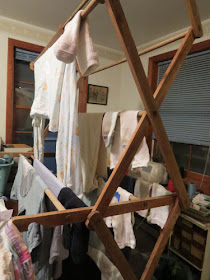 clothes drying on a wooden expanding rack