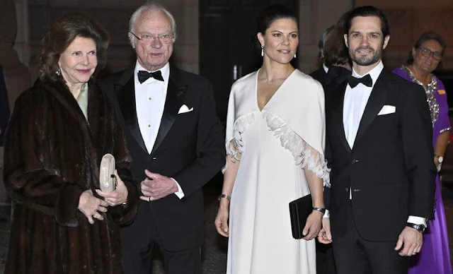 Crown Princess Victoria wore a feather trimmed capelet white satin gown by Toteme. Queen Silvia wore a floral gown